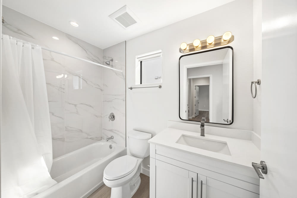 Guest bathroom with tub and vanity